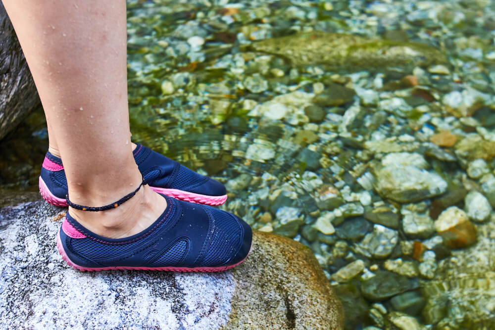 Girl foot on a river