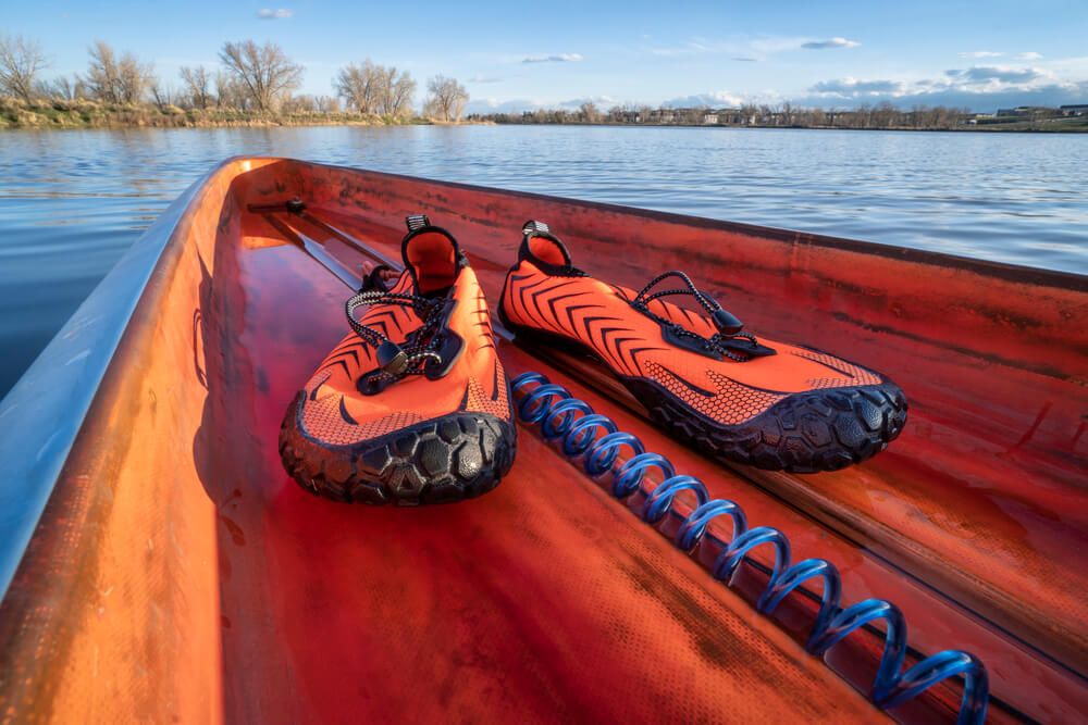 Lightweight low-profile water shoes for kayaking and other wet sports on a deck of a stand up paddleboard
